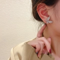 Silver needle hollow zircon butterfly earrings with sparkling cubic stones on model - Butterfly Design / Silver