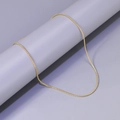 Detailed view of a gold beaded ball chain necklace draped on a grey cylindrical display stand - S-Chain / Gold