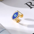 Detail of gold evil eye ring with blue enamel and hammered metal texture finish - Dark Blue Evil Eye