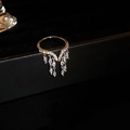 Macro view of gold tassel ring featuring marquise-cut zircons on a dark jewelry display - Zircon Tassel Style / Silver