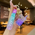 Close-up of cute purple bubble tea keychain with liquid star glitter and silicone wristlet - Purple Luminous Bubble Bead Milk Tea Cup