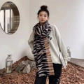 Detail view of zebra print cashmere feel scarf in black beige and brown tones worn by model - 15# Black White Zebra