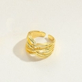 Close-up of golden multi-layer braided open ring with a hollow woven design and wide texture - X-Shaped Braided Style