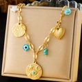 Vintage stainless steel necklace with evil eye and heart charms on a gold jewelry stand - Hamsa Hand and Evil Eye Multi-pendant Style (N3323)
