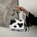 Chic small crossbody bag featuring cow print pattern and wide shoulder strap - Cow Print