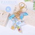 Ocean style resin letter K keychain with blue tassel and mermaid tail charm - Letter K