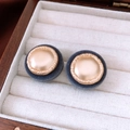 Macro detail of vintage round stud earrings with champagne gold center and flocking - Grey-Gold