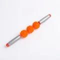 Detail of a manual muscle massage roller featuring three orange spiky balls and gray handles - 3-Ball Orange