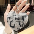 Gray and black leopard print plush heart keychain held in hand for bag charm - Grey Heart Leopard Pom Pom