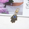 Hamsa-Hand-Schlüsselanhänger mit blauem bösen Auge und Kristallen auf Goldbasis - Gold Schwarze Hand