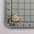 Detailed close-up of a 1cm mini resin cookie charm with eyes on a measuring mat - 07*Cookie Mini