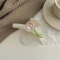 Detail of elegant calla lily hair claw clip with pearlescent pink and white floral finish - Elegant White