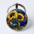 Silver metal round keychain featuring a sunflower and blue butterfly illustration art - Sunflower/Blue Flower Butterfly