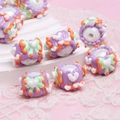 Purple hand-painted resin beads with green, orange, and white heart patterns - White Bead + Purple Cream + Green Bow
