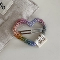 Detail of a rainbow crochet heart hair clip with a cotton label and metal snap fastener - Heart Hair Clip Set