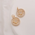 Macro shot of two 14K gold plated star charms with cubic zirconia on a white stone base - Eight-Pointed Star / 15mm