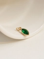 Close-up of 18K gold plated oval green zircon birthstone pendant with intricate details - May/Green