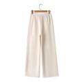 Detail of off-white wide-leg knitted trousers with elastic waistband and decorative stitching - Apricot Pants