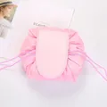 Detailed top view of pink drawstring makeup bag with velcro flap on white background - Light Pink