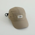 Close-up of quick-dry khaki camp cap featuring black CHANGE label and D-ring strap - Khaki