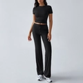 Women's two-piece black lounge set featuring a short sleeve crop top and drawstring pants - S / Black