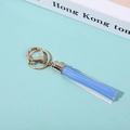 Close-up of golden lobster clasp with blue PU leather tassel and white contrast stitching - Blue and White