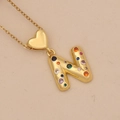 Detail of gold letter N pendant with colorful zircon stones and heart-shaped bail - Letter N / Gold