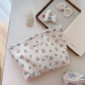 Close-up of cotton floral makeup bag with cherry prints and textured canvas fabric - White Base With Blue Leaves And Red Fruit