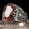 Macro shot of men's punk ring featuring a large orange oval zircon and fleur-de-lis carvings - TJZ22016-Amber Stone Fleur-de-lis