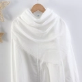 Solid white crinkle cotton linen scarf with frayed edges hanging on a wooden hanger - White