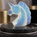 Hand-carved opalite unicorn head sculpture featuring a translucent blue finish - Opalite Unicorn