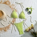 Detailed view of neon green ribbed bikini with white drawstring cut-outs and wavy texture - Light Green