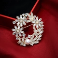 Golden flower brooch with crystals and pearl on red satin next to a gift box - Style 39-1 Round Flower (4.5*4.5cm/15.4g)