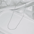 Close-up of minimalist silver chain necklace on white satin with an angel statue - Silver Shimmer O-Chain (45CM)