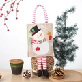 Bolsa de regalo navideña con muñeco de nieve y piernas de rayas rojas y blancas festivas - Muñeco de nieve