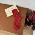 Festive red mid-calf cotton socks with white floral pattern on a warm wooden background - One Size / Colorful Floral