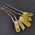 Detailed view of three golden wavy hairpins with raw yellow crystal stones and wire wrap - Yellow Crystal + Gold Comb