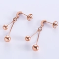 Orecchini a pendente con nappe e perline in oro rosa lucido su sfondo bianco - Oro rosa