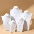 Five-piece gold necklace set with assorted pendants on white mannequin display - 20cm / H-Type White Leather