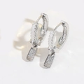 Macro detail of silver zipper-shaped earrings with sparkling cubic zirconia pavé setting - White Zircon (Silver) / Silver With White Zirconia