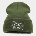 Close-up of white Cat mom embroidery and cat face pattern on green knit beanie hat - One Size / Army Green