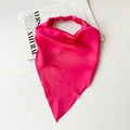 Close-up of rose red satin head scarf with elastic band on a magazine background - Satin Rose Red