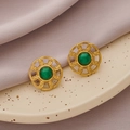 Vintage gold stud earrings with green natural stone on ceramic tray and purple silk background - Gold + Green Jade