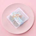 Close-up of cute anime style washi tape set in a transparent storage box for DIY journaling - Girl-Blue Set