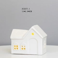 Macro view of white ceramic house LED night light with window cutouts and warm glow - RH2277 (11x6.3x9cm)