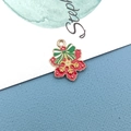 Macro shot of red snowflake enamel pendant with green bow for Christmas DIY jewelry - Snowflake