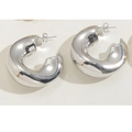 Macro view of chunky silver C-shaped hoop earrings with polished mirror finish - Twisted C-Shape Style (ES2262) / Silver