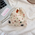 Close-up of cream drawstring bag with bubble texture and Christmas embroidery - Snowman Bear