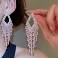 Close-up of elegant gold tassel earrings with rectangular pink zircon stones on model - Pink Rhombus Tassel (6#)