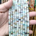 Detailed view of hand-held natural Amazonite stone spacers for DIY jewelry making - Amazonite